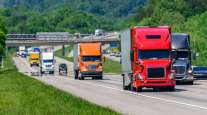 Several semis drive amid on an interstate in Tennessee.